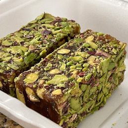 Pistachio halva bars topped with crushed nuts