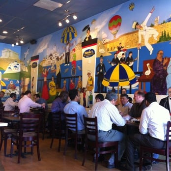 Guests dining beneath Babalou's hand-painted mural
